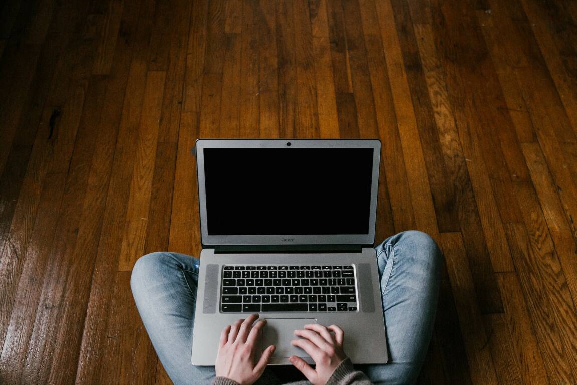 person-in-blue-denim-jeans-sitting-on-floor-using-macbook-4134791